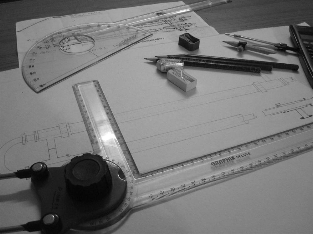 Engineering design drawings on a desk
